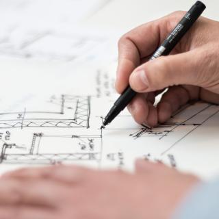 hands sketching an architectural drawing