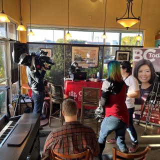 People doing a live broadcast in a coffee shop