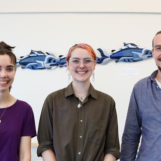 Simon Maguire, Lily Eggert and Trevor Michalchuk stand side-by-side smiling.