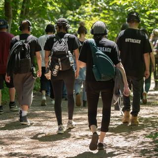 Walk With Me participants go through a forested area