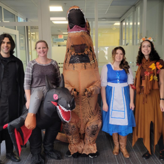 People dressed up in Halloween costumes in an office