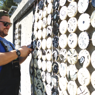 Joe Lyons in front of the mural project