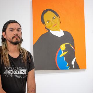 Atticus Mercredi with the portrait he painted of his mother.