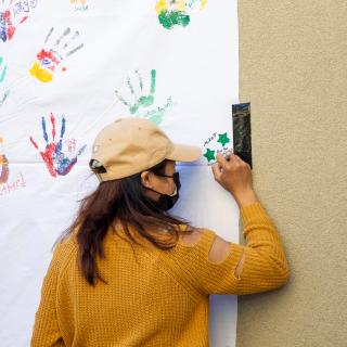 Woman writing on poster