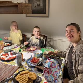 A breakfast table with two children and a female adult