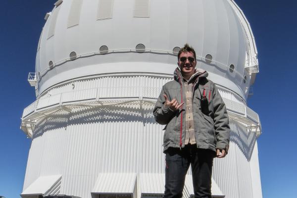 Cam Wipper in front of the Canada-France-Hawaii Telescope