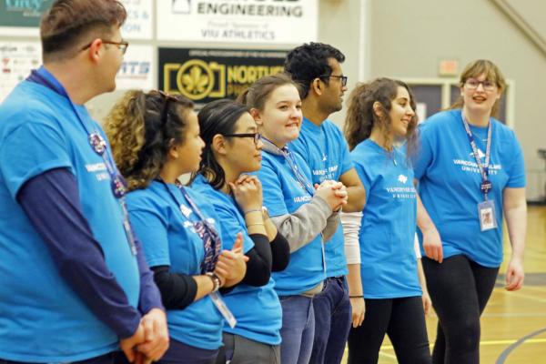 a group of students wearing VIU T-Shirts addresses a crowd