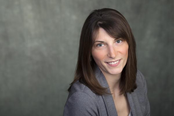 Dr. Lindsay McCunn smiles at the viewer while wearing a grey blazer and shirt.