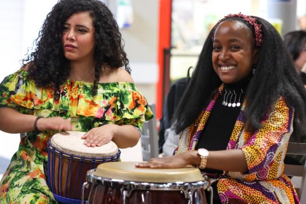 Two women play drums