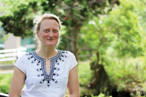 Jenni Ottilie Keppler stands on the koi pond bridge at Vancouver Island University's Nanaimo campus.