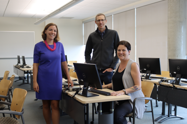 From left to right: Tracy Vandermolen, Darrell Harvey and Anwen Burk in a computer lab and smiling at the camera