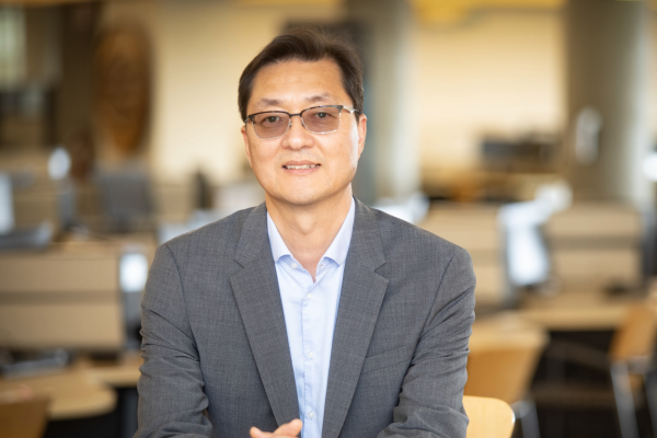 Dr. Sungchul Cho sitting at a desk and smiling at the camera.