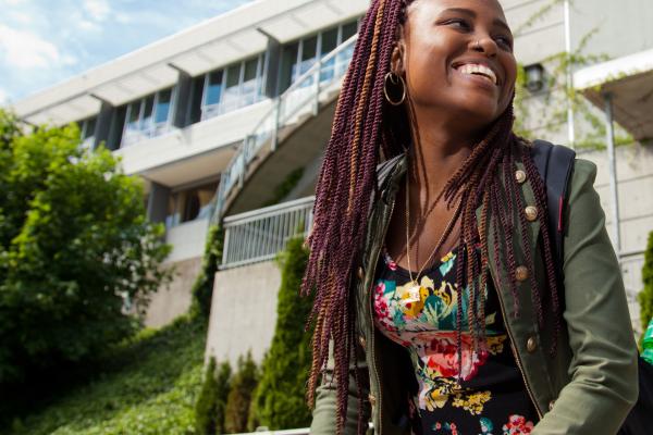 student smiling outside of library