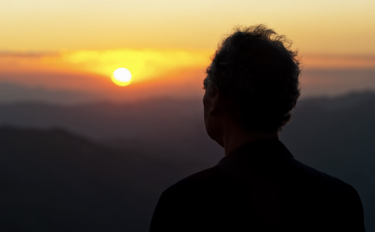 silhouette of a man watching the sunset