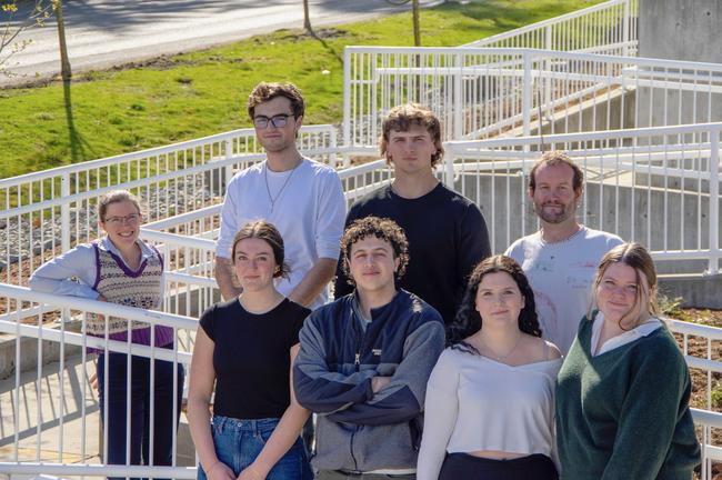 A group of people pose on a ramp