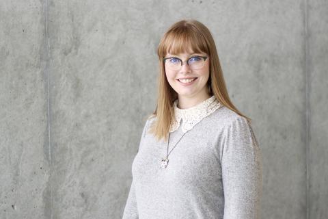 Heather Wiebe wearing a grey shirt, smiles.