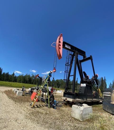 power engineers working on an oil digging rig on a sunny day