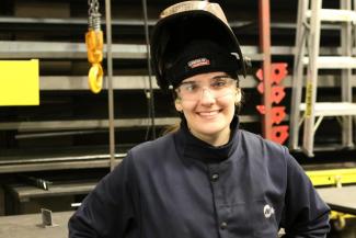 Girl posing with welding shield